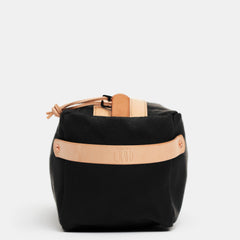End view of black Crud toiletry bag with leather strap embossed Crud Göteborg Sweden