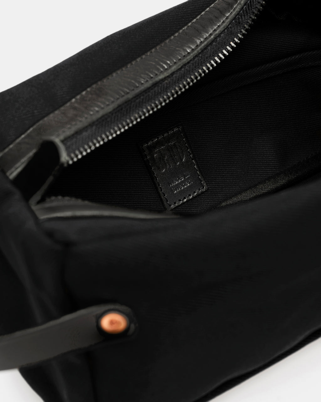 Inside of black toiletry bag with black Crud Made in Sweden label