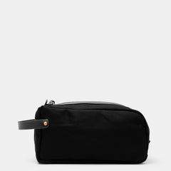 All-black waxed canvas toiletry bag with black leather handle by Crud