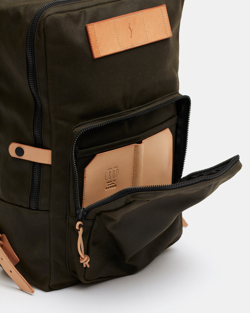 Heavy-duty leather and waxed canvas backpack with brass zippers