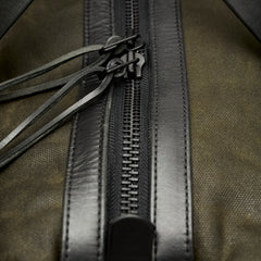 Waxed canvas duffle bag with leather details and extendable strap